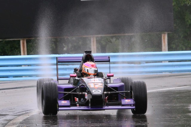 Formula Car Racing in The Rain